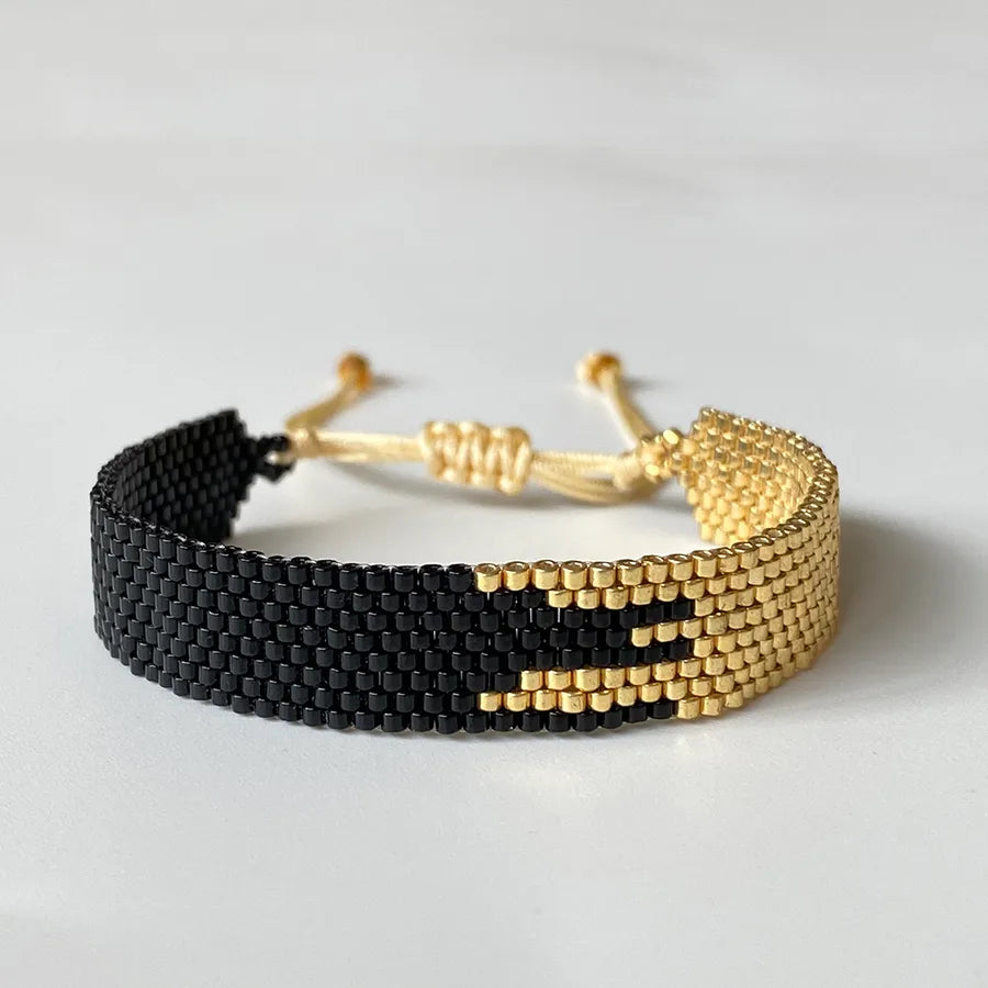 pulsera-asteria-doradoynegro-vistafrontal.jpg